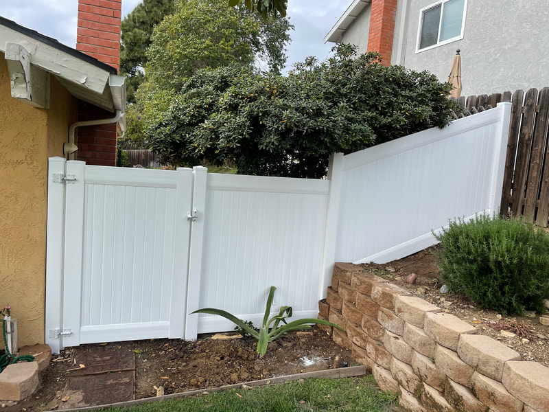 white vinyl fencing on a slope